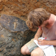 ULAS archaeologist Adam Clapton recording the shield when it was still in the ground.